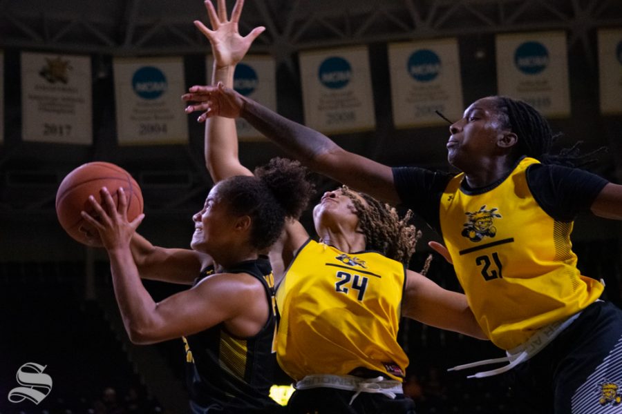 Sophomore Seraphine Bastin jumps for the basket trailed by sophomore Trajata Colbert and senior Maya Brewer during the Black and Yellow Scrimmage on Oct. 5 at Koch Arena.