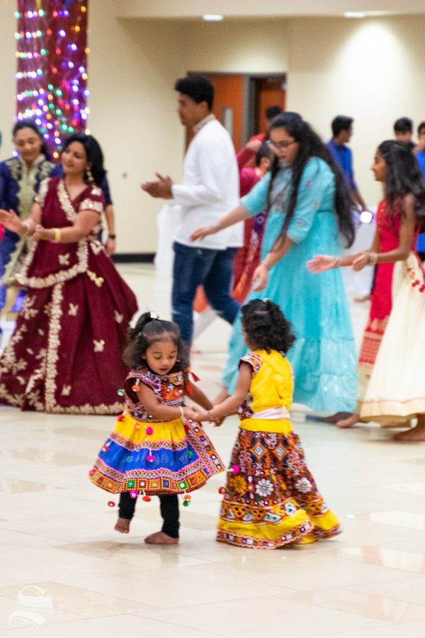 Children dance together near the altar set up for Garba Night 2019 on Oct. 5 in Beggs Ballroom.