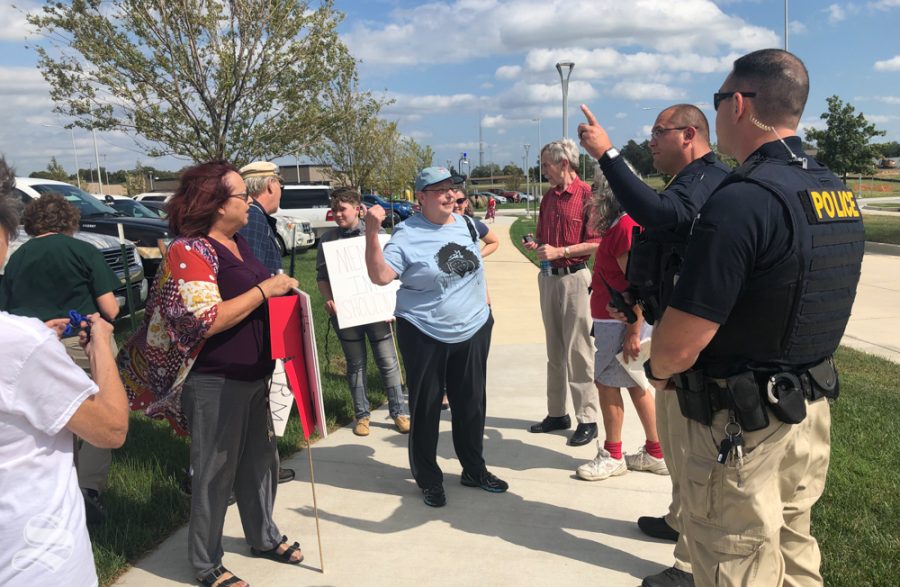 Protesters argue with officers about if they have to move from in front of the Law Enforcement Training Center ahead of Attorney General Bill Barr's October visit. Protesters were ultimately allowed to stay.