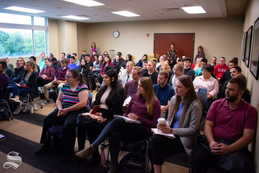 Students listen to tips provided by panelists during the Risk Management Association Panel Discussion on Oct. 10 in the Rhatigan Student Center. The panel had to be moved to a larger room with more space to accommodate the number of students who attended the event.