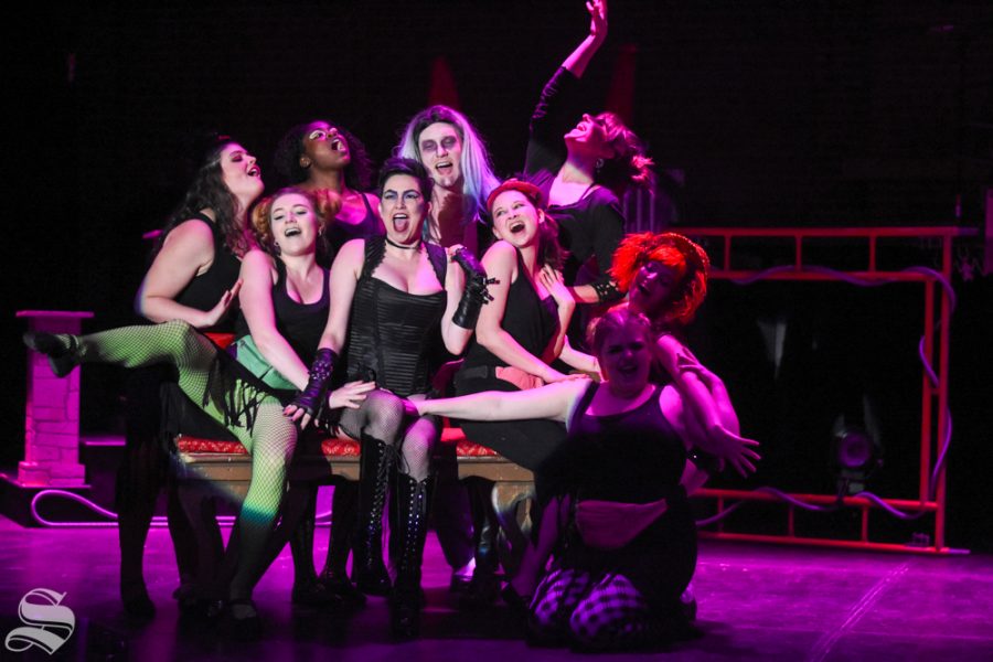 Dr. Frank-N-Furter, played by Molly Tully, sits on a couch and sings with Riff Raff,  Magenta, Columbia,  and the Phantoms during the number “Sweet Transvestite” during a dress rehearsal of The Rocky Horror Picture Show on Oct. 22.