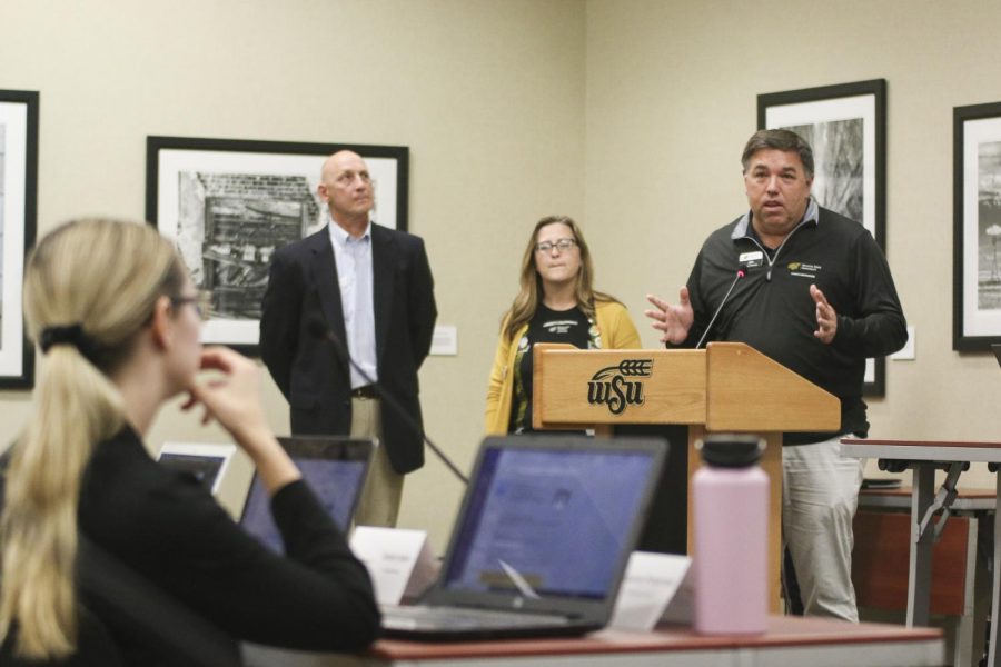 Director of Campus Recreation, John Lee, speaks during public forum at Wednesdays SGA meeting. To his left: George Sorenson, director of the Greater Wichita YMCA, and Jessica Provines, director of Counseling and Prevention Services.