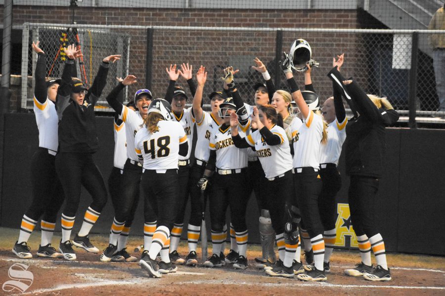 Wichita State teammates cheer for freshman Kiersten Nixon after she hit a home run during the game against Cowley Community College on Oct. 21. The Shockers defeated the Tigers 21-1.