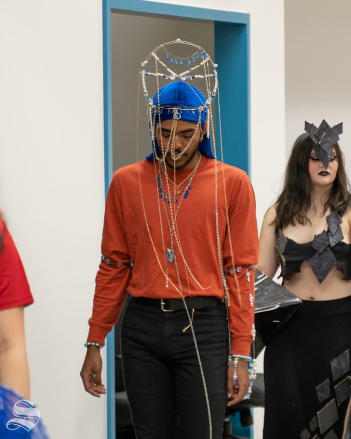 Foundation 3D design student, Che Littlefield, showcases his wearable sculpture design during the re-opening of WSU ShiftSpace on Oct. 4.