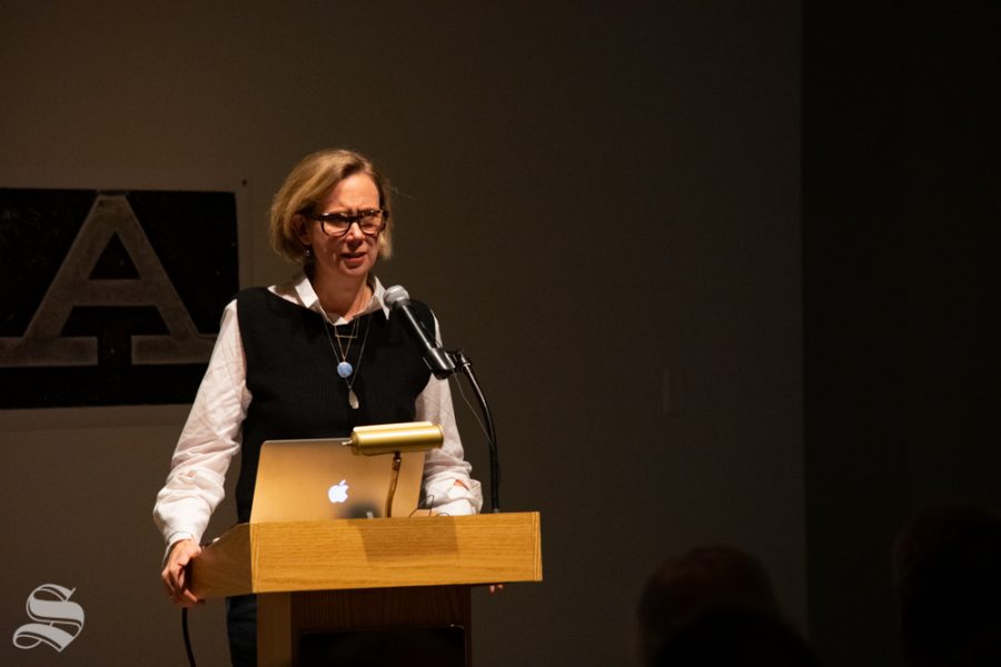 Catherine Morris, the senior curator for at the Sackler Center for Feminist Art, speaks to a crowd about a collection of art and the feminist perspective as it pertains to the pieces during the Tuesday, Nov. 5 Voices from the Vault / Curatoring in the Key of F Minor event at the Ulrich Museum of Art.
