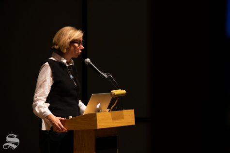 Catherine Morris, the senior curator for the Sackler Center for Feminist Art, speaks to a crowd about a collection of art and the feminist perspective as it pertains to the pieces during the Tuesday, Nov. 5 Voices from the Vault / Curatoring in the Key of F Minor event at the Ulrich Museum of Art.