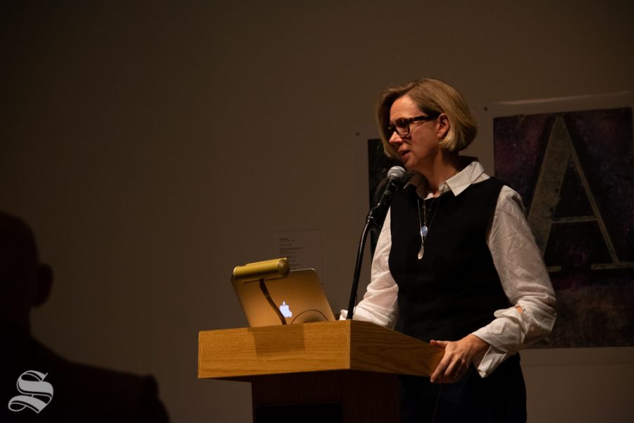 Catherine Morris, the senior curator for at the Sackler Center for Feminist Art, speaks to a crowd about a collection of art and the feminist perspective as it pertains to the pieces during the Tuesday, Nov. 5 Voices from the Vault / Curatoring in the Key of F Minor event at the Ulrich Museum of Art.