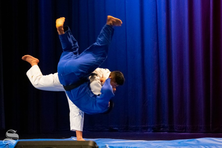 Sophomore Akishige Kuraishi drops junior Stefano Bardelli to their crash mat during Wichita States Judo Club demonstration during Japanese Culture Night on Friday, Nov. 1 at the CAC Theater.