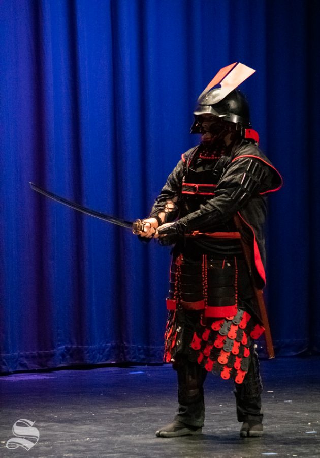 Tora Lawson, sensei of the Tosa No Shugyo Dojo, performs an armored sword demonstration during Japanese Culture Night on Friday, Nov. 1 at the CAC Theater. Lawson founded the Tosa No Shugyo school in Wichita after 34 years of study in Japanese martial arts.