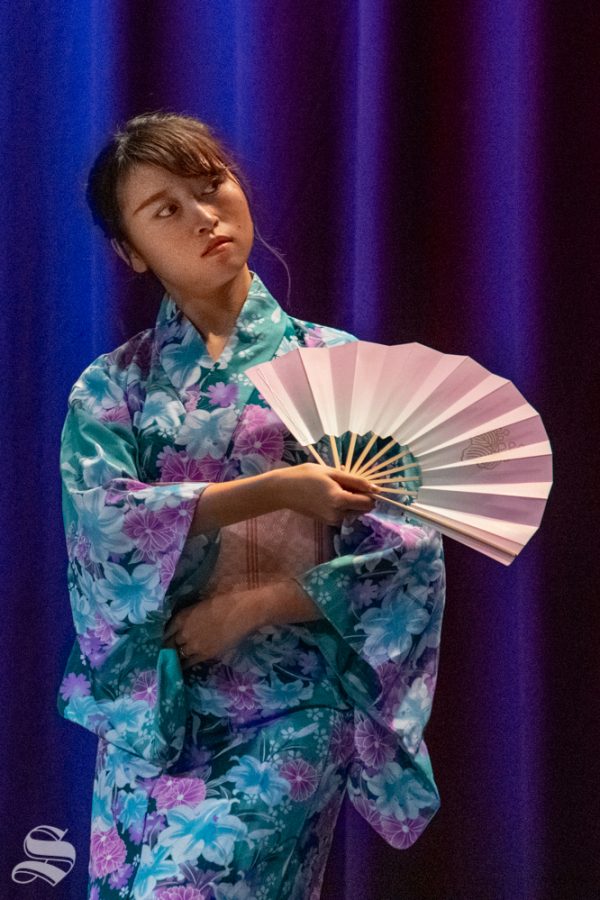 Freshman Marina Hata performs a traditional fan dance during Yokoso: Japanese Culture Night on Friday, Nov. 1 at the CAC Theater.