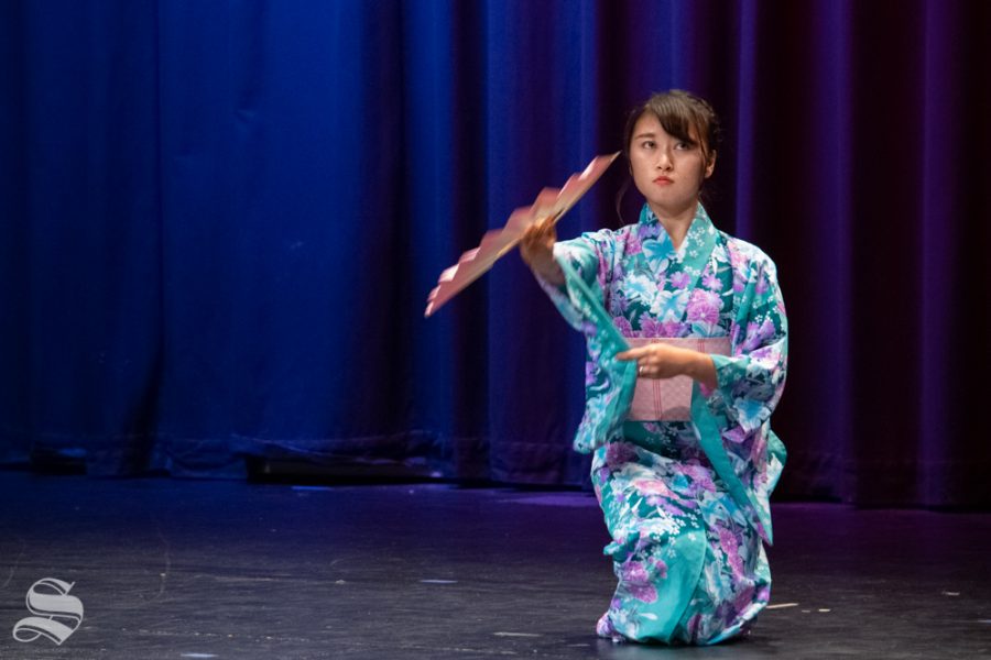 Freshman Marina Hata performs a traditional fan dance during Yokoso: Japanese Culture Night on Friday, Nov. 1 at the CAC Theater.