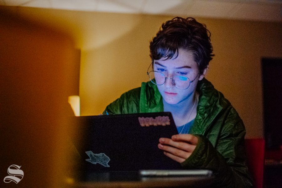 Daria Moore, a freshman studying biological sciences and graphic design, draws using a laptop during the LGBT self-care event on Thursday, Nov. 7 at the Office of Diversity and Inclusion.