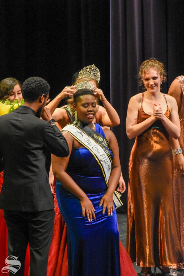 Sophomore and Columnist Kamilah Gumbs recieves her crown after winning the Miss Black and Gold Pageant on Friday, Nov. 8 in the CAC Theatre.