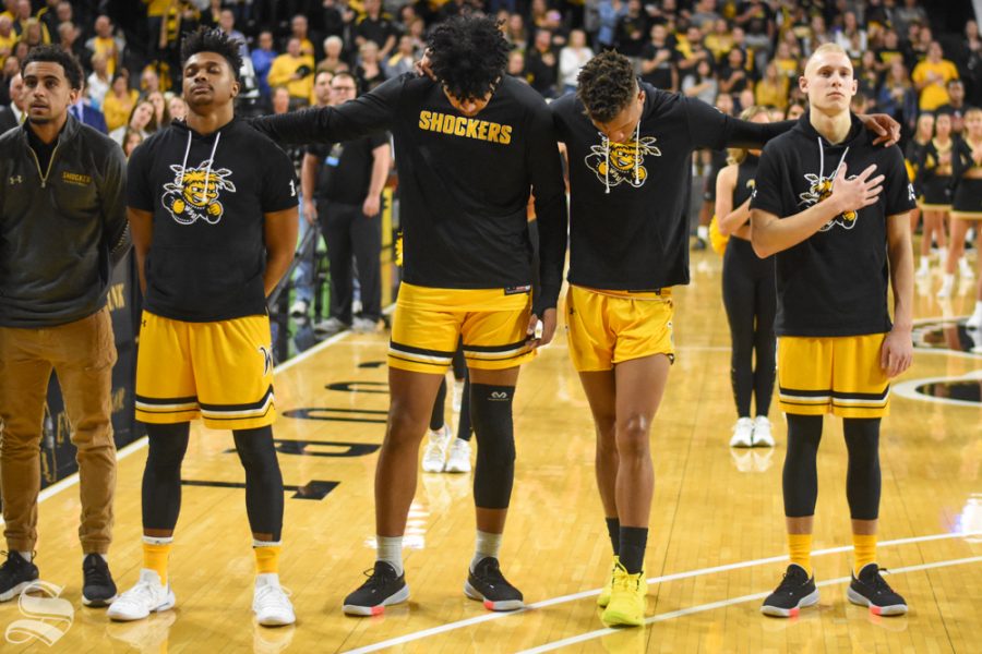 Wichita+States+Tyson+Etienne%2C+Isaiah+Poor+Bear-Chandler%2C+Dexter+Dennis%2C+and+Brycen+Bush+stand+together+during+the+national+anthem+before+the+game+agianst+Omaha+on+Tuesday.