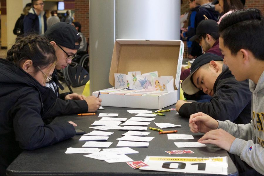 Students color pictures of various Pokemon as part of the Asian Student Conference’s Pokemon festival on Wednesday in the RSC. Participants at the event made their way through different stations to collect all eight gym badges and become a Pokemon Master.