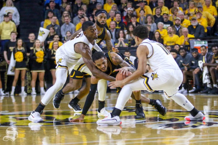 Wichita States Trey Wade and Noah Fernandes cause a jump ball during the first half of the game against VCU on Saturday inside Charles Koch Arena.