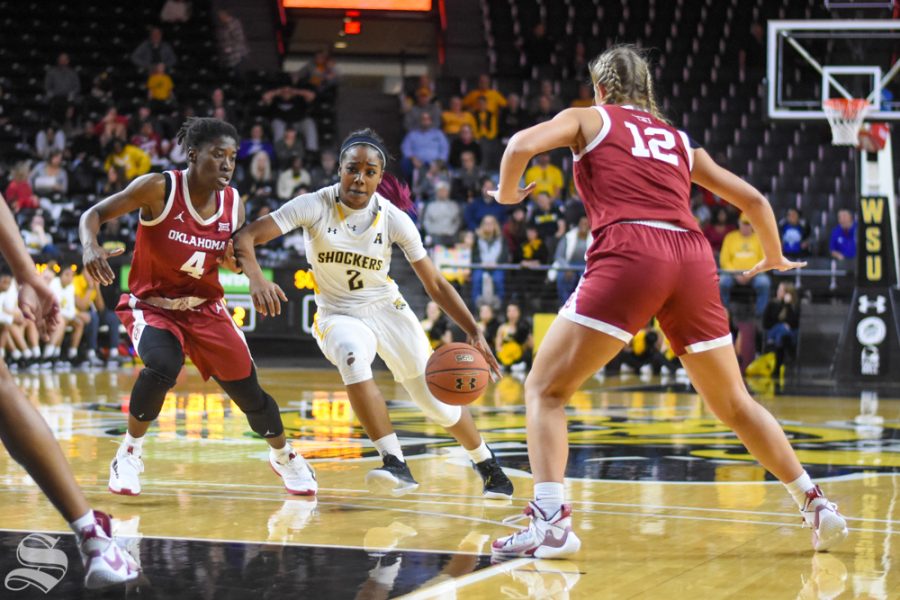 Wichita States Mariah McCully dribbles past defenders during the second quarter of the game against the Oklahoma Sooners on Saturday.