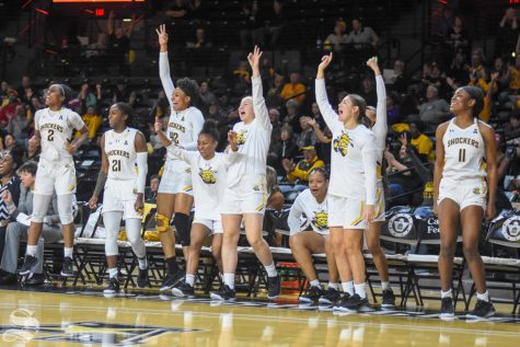 Wichita State players celebrate from the bench after scoring a three against the Oklahoma Sooners on Saturday, Nov. 30 inside Charles Koch Arena.