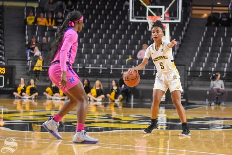 Wichita States Ashley Reid looks for a pass above the three-point line during the game against the Memphis Tigers on Wednesday.