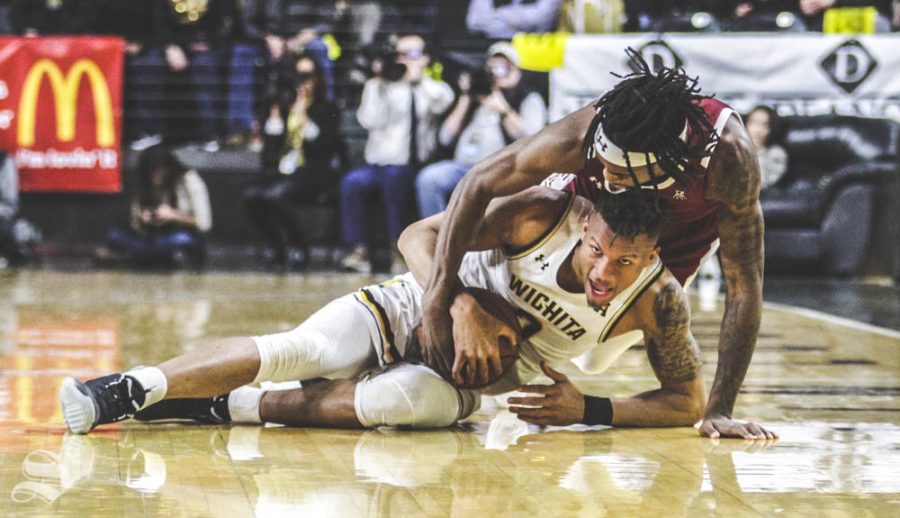 Wichita State sophomore Dexter Dennis fights for the ball with Temple's Quinton Rose during the first half of the game against the Owls on Feb. 27 inside Charles Koch Arena.