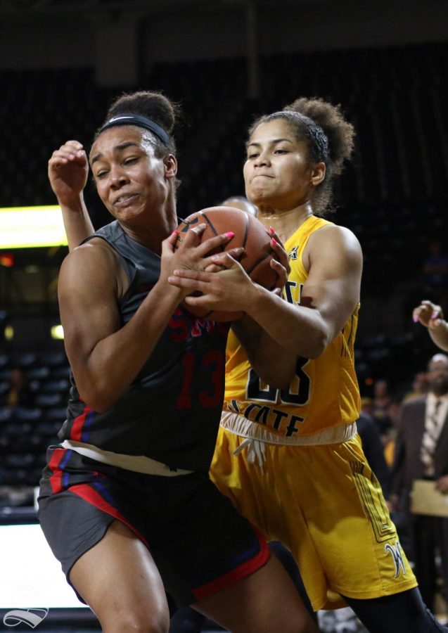 Southern Methodists Reagan Bradley and Wichita States Seraphine Bastin wrestle over a rebound during the game at Charles Koch Arena on Wednesday, Feb. 19, 2020. 