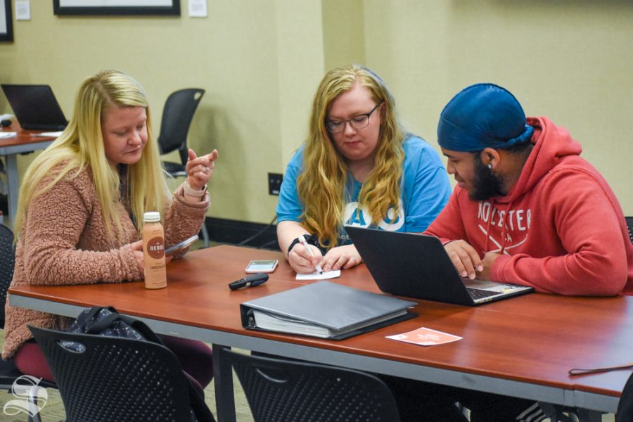 Wichita State students Royce Siebert and Donavon Cheeks speak with SAC president Emily Liston during a meeting that took place earlier in the semester.