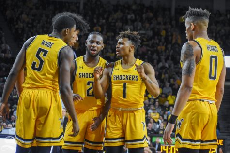 Freshman Tyson Etienne speaks to his teammates in a huddle during the game against Tulane on Feb. 16 inside Charles Koch Arena.