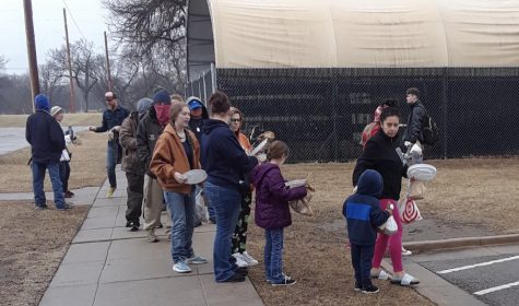The Coalition: ICT hands out food to homeless and vulnerable Wichitans last week in Riverside Park.