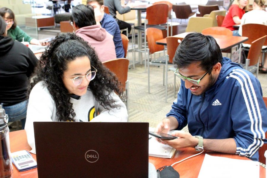 Junior aerospace engineering student Shubhrojit Bhattacharya and freshman mechanical engineering student Irene De Giacomi laugh after reading the COV-19 class suspension update.