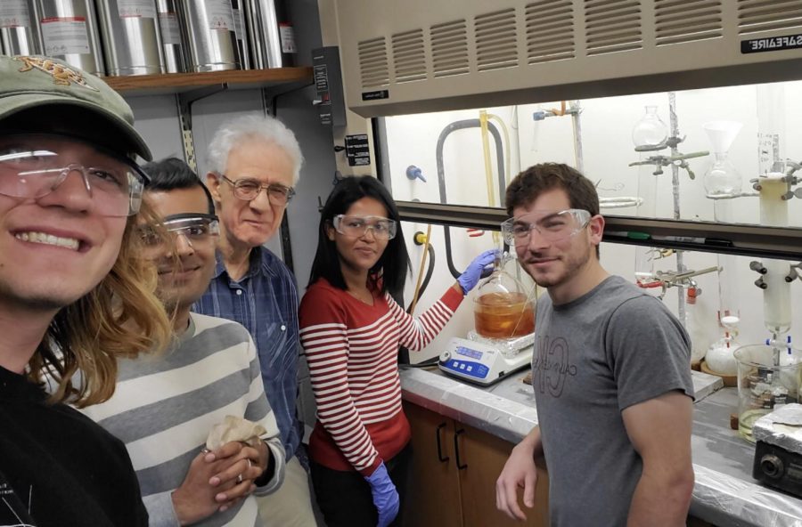 William Groutas, a bioorganic and medicinal chemistry professor at Wichita State (center) and research assistants pose in Groutass research laboratory at WSU.