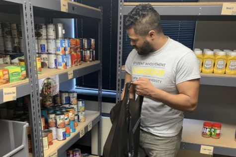 Collin Munson loads up food for delivery in the Shocker Support Locker.