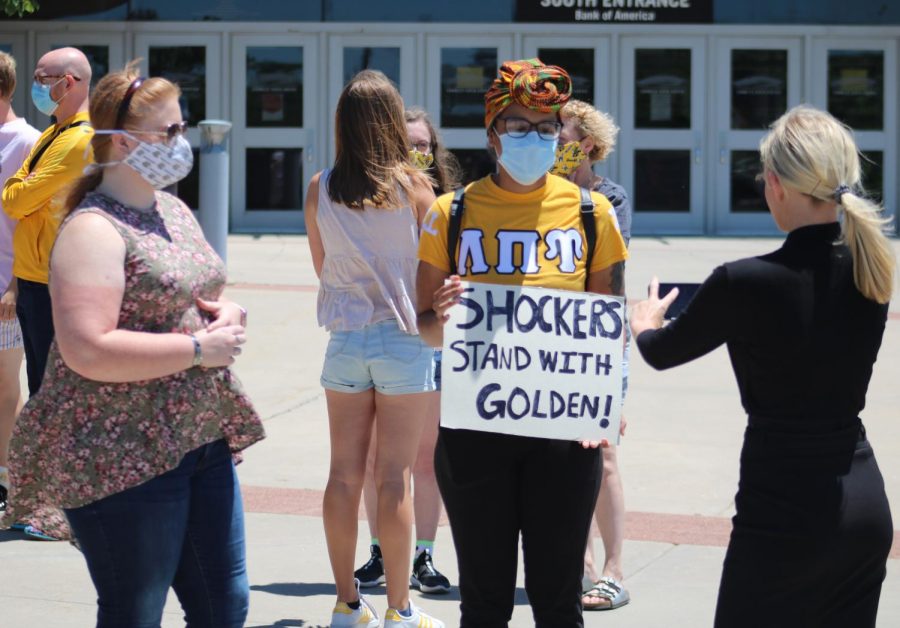 A student protester holds a sign that says Shockers stand with Golden during an impromptu rally in support of President Jay Golden on Wednesday afternoon. The rally was organized in response to calls for his resignation after WSU Tech canceled a virtual commencement speech from Ivanka Trump.