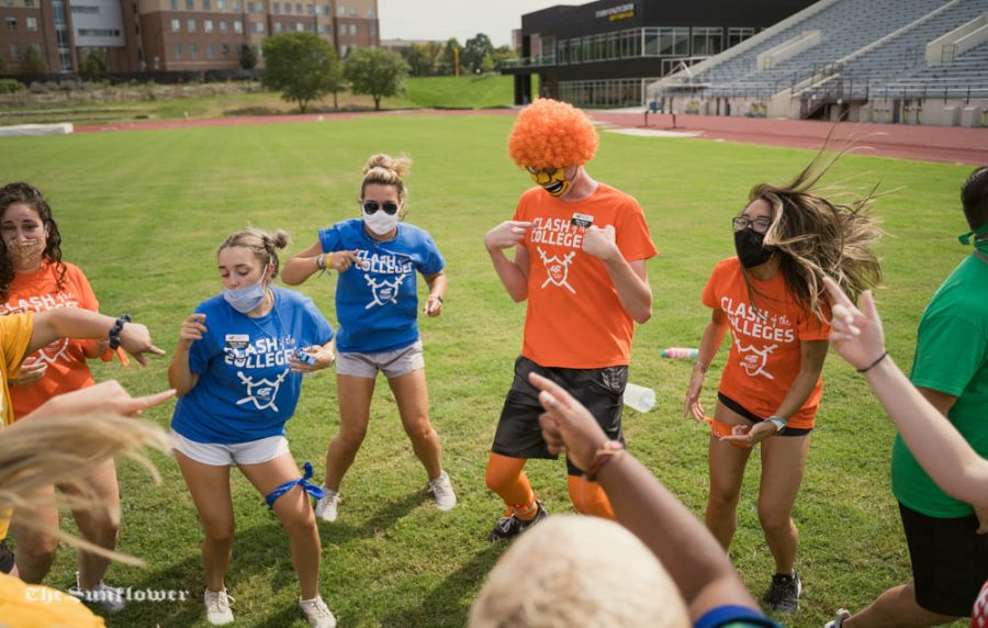 Event staff members warm up before the start of Clash of the Colleges. The event was held on Friday, Aug. 21 at Cessna Stadium.