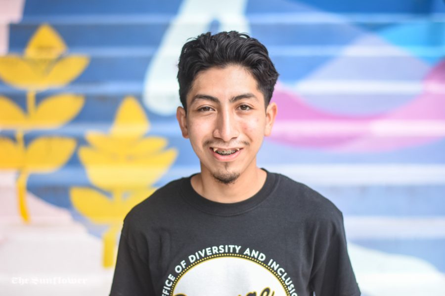 Jordy Mozqueda, a freshman general business major, poses for a photo in front of a mural at Clinton Hall. 