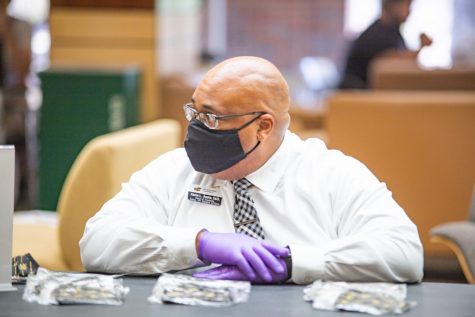 Aaron Austin, Dean of Students, passes out masks on the first day of fall classes inside the RSC on August 17.