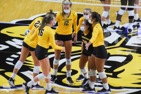 Wichita State's yellow team goes in for a huddle during the Black and Yellow Scrimmage on Saturday, Sep. 12.