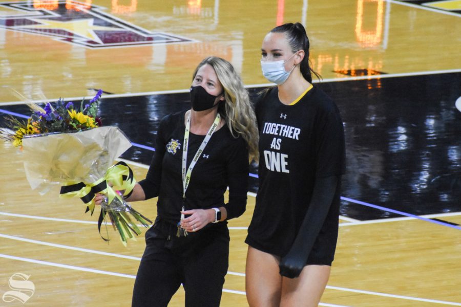 Wichita State senior Emma Wright walks with Director of Operations Shannon Lamb during her senior recognition during the Black and Yellow Scrimmage on Saturday, Sept. 12 inside Charles Koch Arena.
