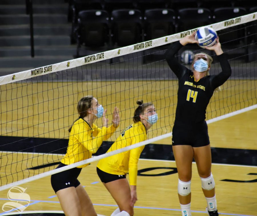 Wichita State senior McKayla Wuensch sets the ball to her teammate during a scrimmage on Sept. 12 inside Charles Koch Arena.