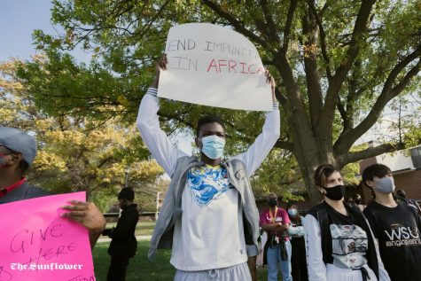A member of the African Student Associasion holds up a sign during the protest.