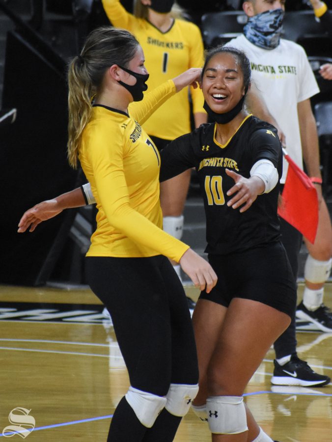 Sophomores Sina Uluave and Nicole Anderson embrace each other after scoring against the yellow team during the scrimmage on Friday, Oct. 16, inside Charles Koch Arena.