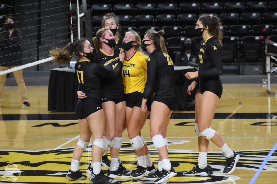 The black team celebrates after scoring against the yellow team in the fifth set during the Black and Yellow Scrimmage on Friday, Oct. 16. 