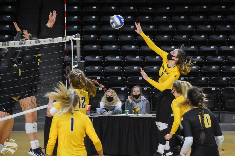 Sophomore Nicole Anderson spikes the ball during the Black and Yellow Scrimmage on Friday inside Charles Koch Arena.