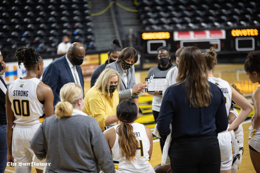 Head coach Keitha Adams talks to the team during the game against the South Dakota Coyotes at Charles Koch Arena on Dec. 10.