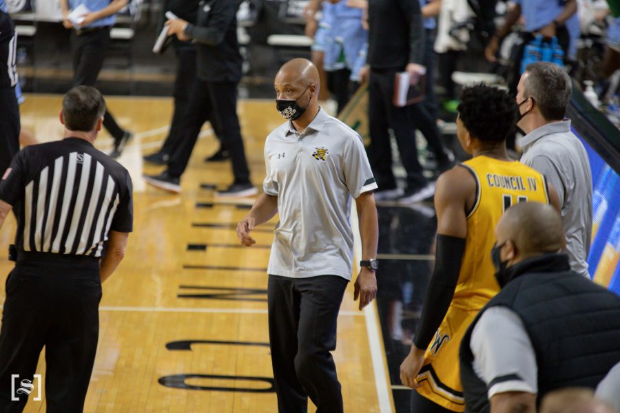 Interim Head Coach Isaac Brown talks to a ref during the game against Tulane at Charles Koch Arena on Feb. 3.