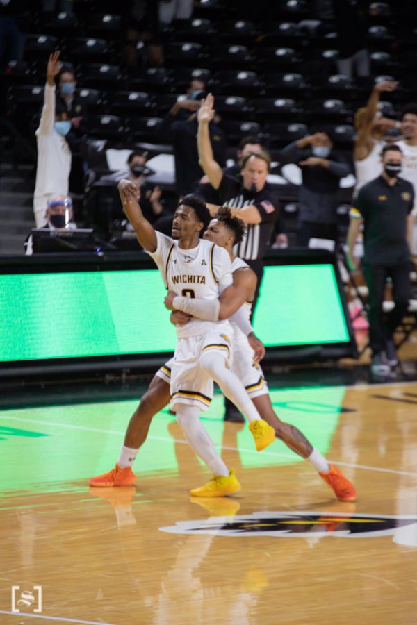 Wichita State Alterique Gilbert celebrates with Tyson Etienne after hitting a 3-pointer during the game against Houston at Charles Koch Arena on Feb. 18.