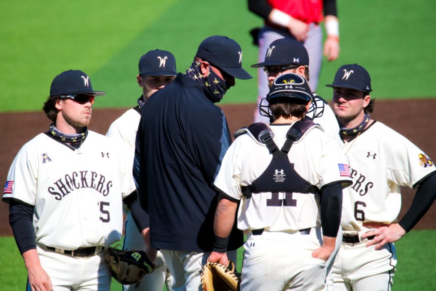 Wichita State baseball players talk to pitching coach Mike Pelfrey during a game at Eck Stadium on Feb. 28