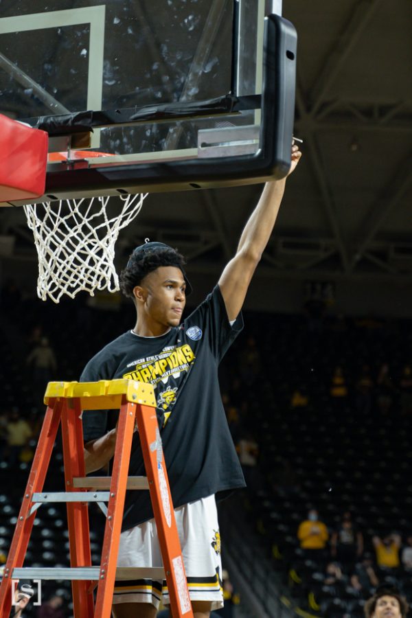 Wichita State freshman Ricky Council IV cuts the net celebrating Wichita State first AAC regular season title on March 6 at Charles Koch Arena.