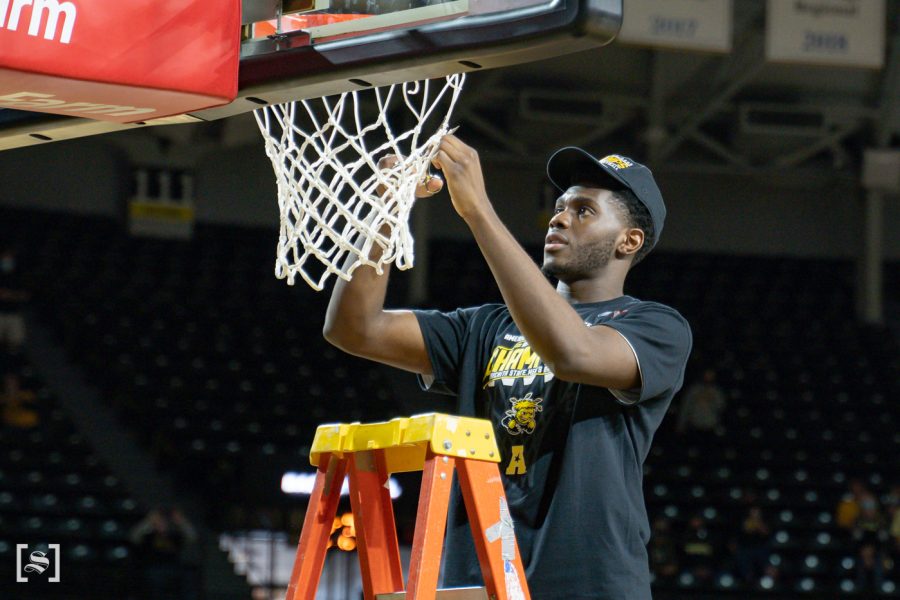 Wichita State redshirt freshman Josaphat Bilau cuts the net celebrating Wichita State first AAC regular season tittle on March 6 at Charles Koch Arena.