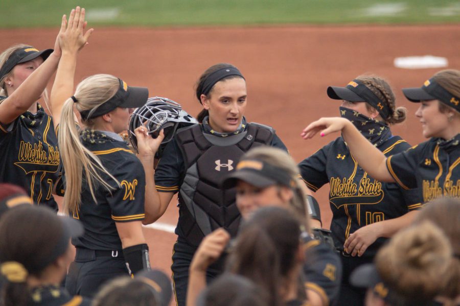 Wichita State senior Madison Perrigan gathers with her teammates during the game against Oklahoma State at Wilkins Stadium on April 27, 2021.