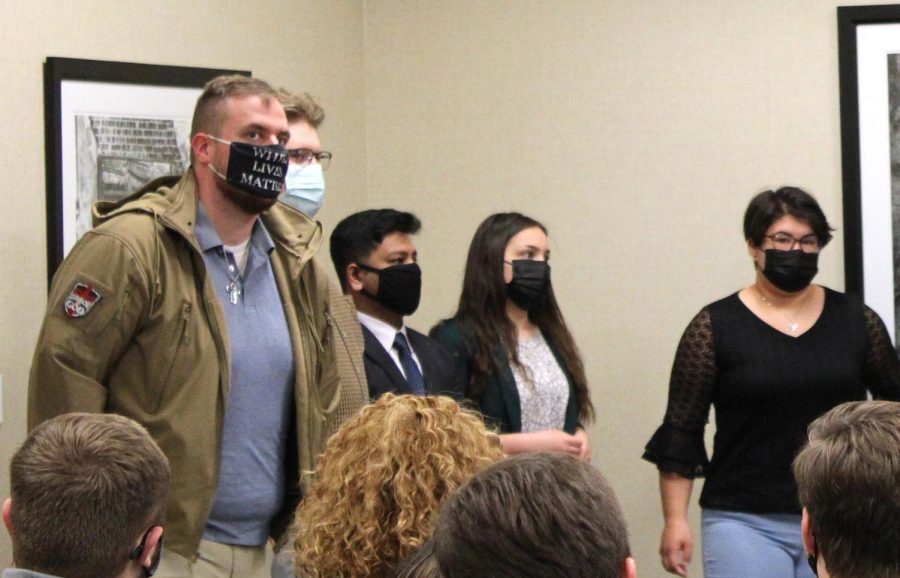 Samuel McCrory, left, is sworn in as a returning adult Student Government Association senator on April 22, 2021. His white lives matter mask sparked controversy online.
